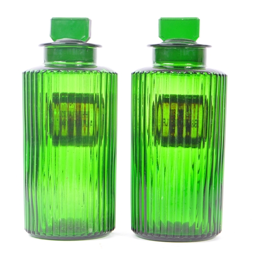 146 - A pair of 20th Century green glass Apothecary chemist poison bottles of circular form with ribbed ef... 