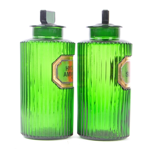 146 - A pair of 20th Century green glass Apothecary chemist poison bottles of circular form with ribbed ef... 