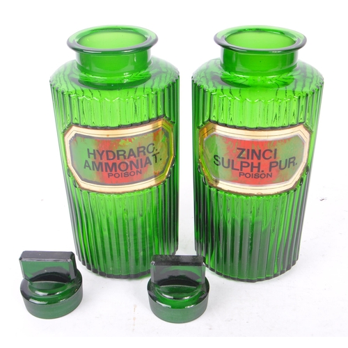 146 - A pair of 20th Century green glass Apothecary chemist poison bottles of circular form with ribbed ef... 