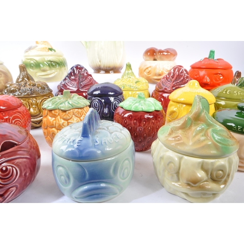 150 - Sylvac - A large collection of twenty one ceramic vegetable and sauces ' Face Pots ' by Sylvac to in... 