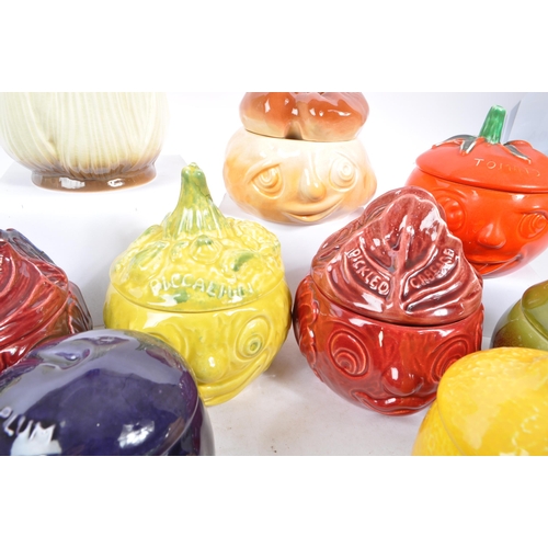 150 - Sylvac - A large collection of twenty one ceramic vegetable and sauces ' Face Pots ' by Sylvac to in... 