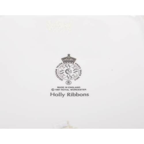 154 - Royal Worcester - A collection of three bone china Royal Worcester pieces in the ' Holly Ribbons ' p... 