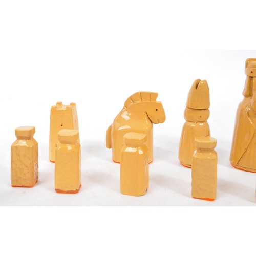 161 - A ceramic handmade terracotta and stoneware colouring chess set with glazed finish and orange felt t... 