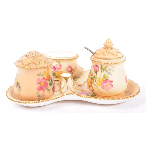 166 - Royal Worcester - Ivory blush cruet set having three condiments on trefoil stand. Handle AF.