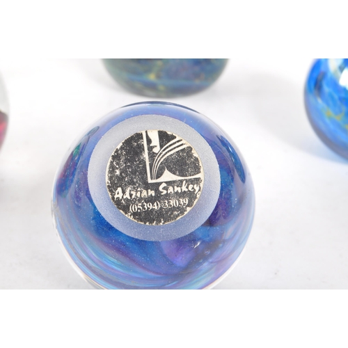 188 - A collection of 20th century glass paperweights. Including apple form examples, stem vase, signed md... 