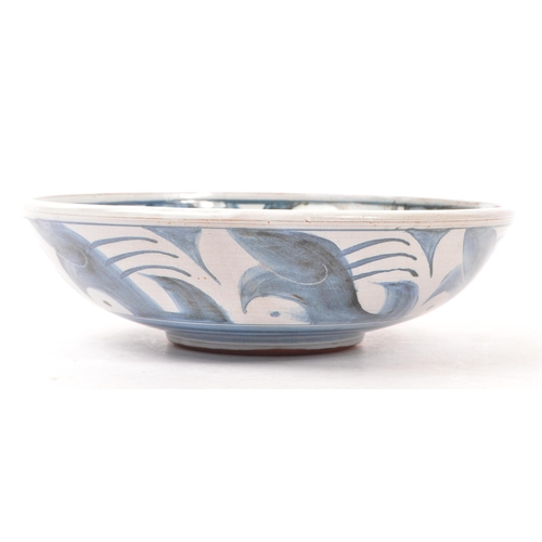 194 - Pat Birks (contemporary) - A pottery ceramic hand painted fruit bowl. In blue and white tones with g... 