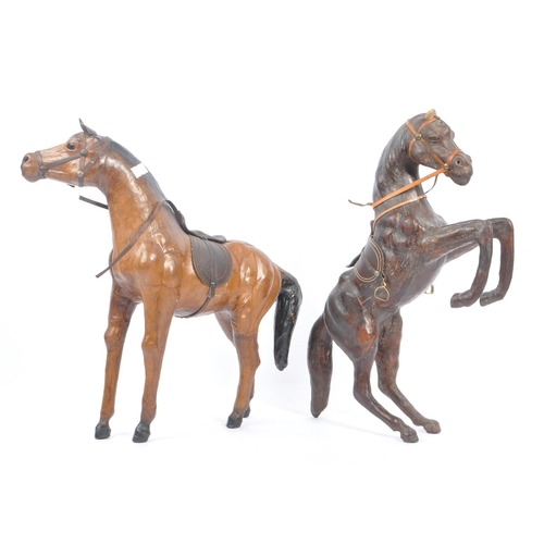 208 - Manner of Liberty & Co - Two 20th Century vintage large brown leather horse models in the style of L... 