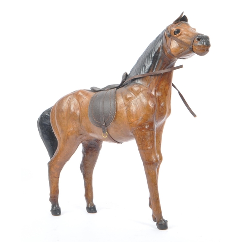 208 - Manner of Liberty & Co - Two 20th Century vintage large brown leather horse models in the style of L... 