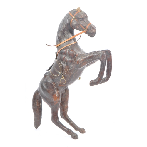 208 - Manner of Liberty & Co - Two 20th Century vintage large brown leather horse models in the style of L... 