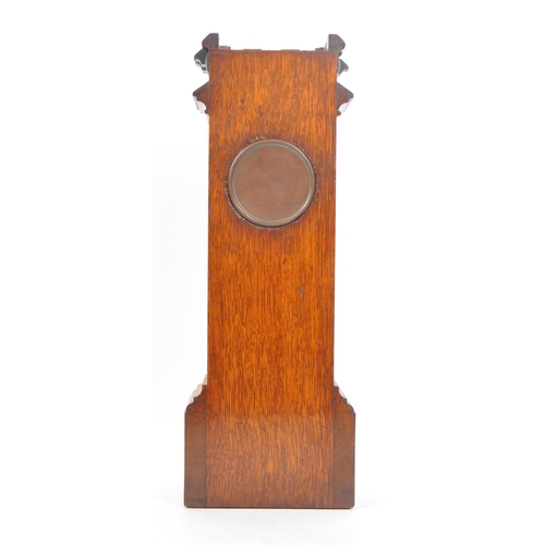 210 - An early 20th century oak mantel clock barometer. The clock sat on a plinth base, stepped to top, be... 