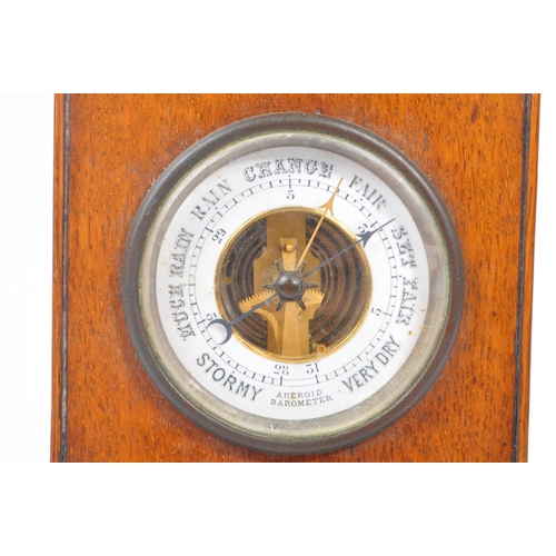 210 - An early 20th century oak mantel clock barometer. The clock sat on a plinth base, stepped to top, be... 