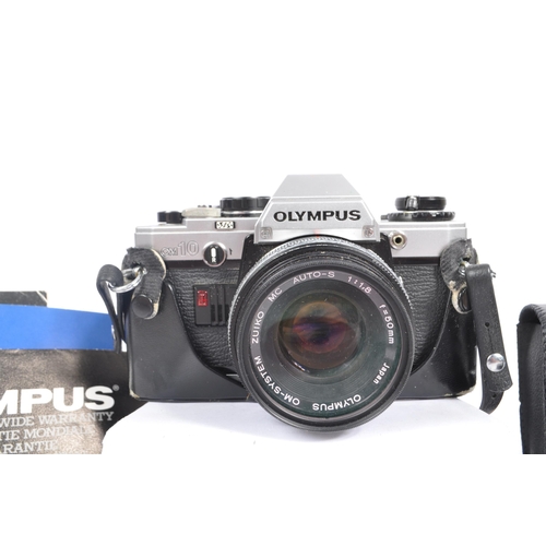 213 - Olympus - A late 20th century circa 1980s OM10 35mm SLR camera with lens and accessories. The camera... 