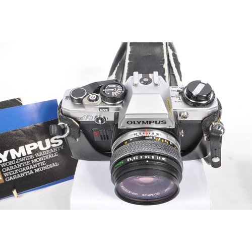 213 - Olympus - A late 20th century circa 1980s OM10 35mm SLR camera with lens and accessories. The camera... 