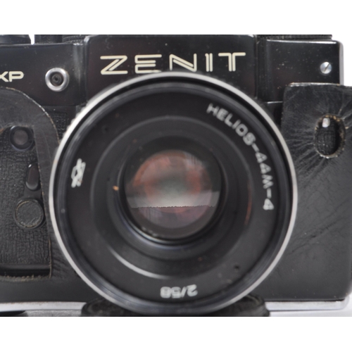 216 - Zenit - A mid 20th century Zenit / Zenith 12XP 35mm SLR camera. The camera having a black body in or... 