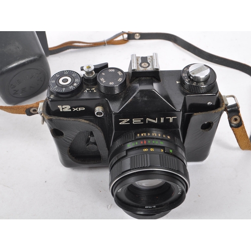 216 - Zenit - A mid 20th century Zenit / Zenith 12XP 35mm SLR camera. The camera having a black body in or... 