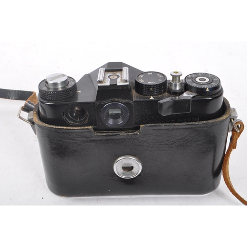 216 - Zenit - A mid 20th century Zenit / Zenith 12XP 35mm SLR camera. The camera having a black body in or... 