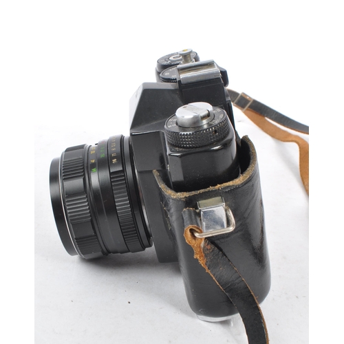 216 - Zenit - A mid 20th century Zenit / Zenith 12XP 35mm SLR camera. The camera having a black body in or... 