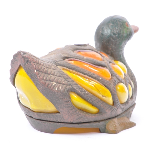 220 - An Art Nouveau style bronze duck lamp shade / lantern with glass inset detailing to body in yellow a... 