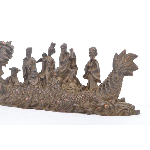 229 - Two Chinese bronze figure ornaments. One fuk luk sau in a dragon boat on a naturalistic sea base, to... 