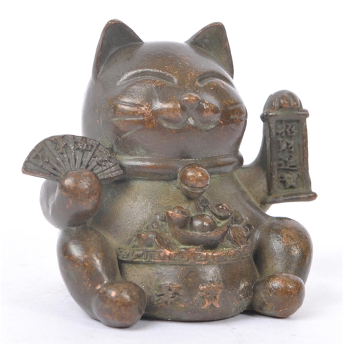 230 - Two Chinese bronze figure ornaments. Comprising of lucky cat holding a fan in a seated position toge... 