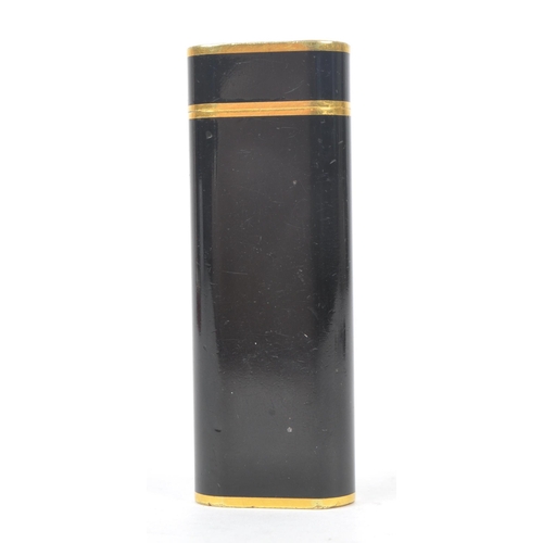 237 - A 20th Century French vintage Must de Cartier Paris 'Trinity' black lacquer and gold plated lighter ... 