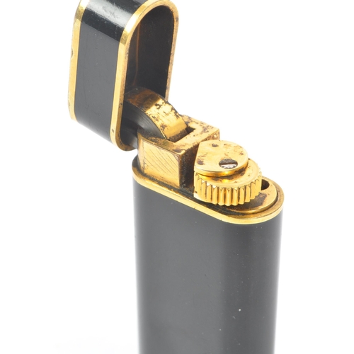 237 - A 20th Century French vintage Must de Cartier Paris 'Trinity' black lacquer and gold plated lighter ... 