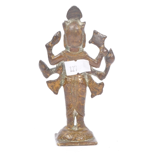 243 - A small brass Indian figure in the form of the Hindu God Vishnu depicted with four arms, heavily jew... 