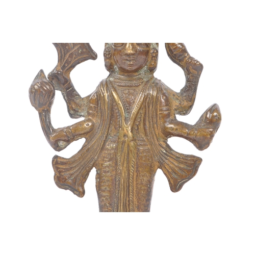 243 - A small brass Indian figure in the form of the Hindu God Vishnu depicted with four arms, heavily jew... 