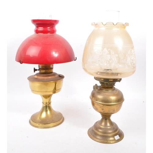 244 - Two vintage 20th century brass table oil lamps. Having glass flutes, with circular shades on brass s... 