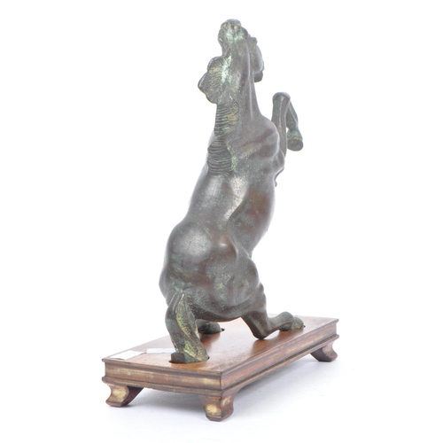 247 - A 20th century Chinese bronze horse statue figure on wooden stand. The horse raised on its hind legs... 