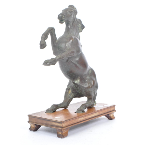 247 - A 20th century Chinese bronze horse statue figure on wooden stand. The horse raised on its hind legs... 