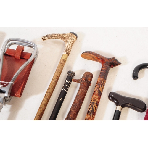 248 - A vintage 20th century brass Indian stick / walking stick stand. With a collection of swagger stick ... 