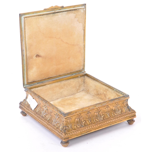 256 - A 19th Century French brass hinged ornamental jewellery box of square form having central vignette d... 