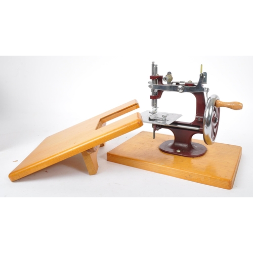 270 - Essex - A vintage mid 20th century Essex miniature sewing machine. The machine held within a leather... 