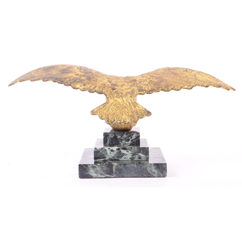 281 - A 20th Century ormolu bronze gilt eagle figure with wings spread and clawed feet holding a ball atop... 