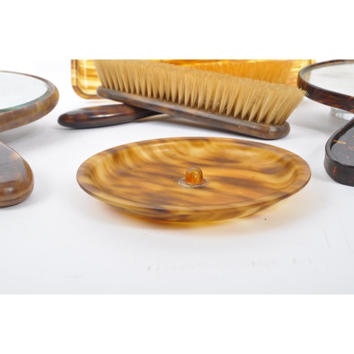 292 - An early 20th century xylonite celluloid vanity set. The set in a tortoise shell colouring, consisti... 