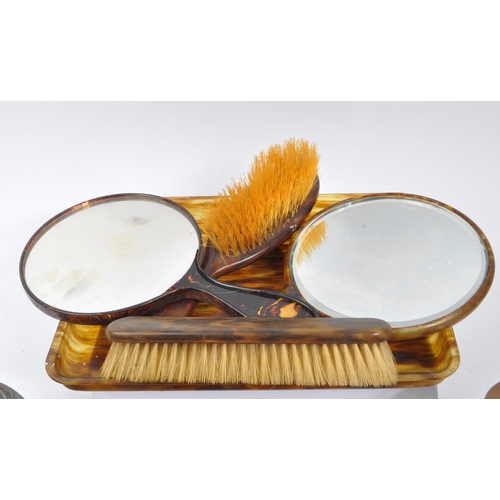 292 - An early 20th century xylonite celluloid vanity set. The set in a tortoise shell colouring, consisti... 