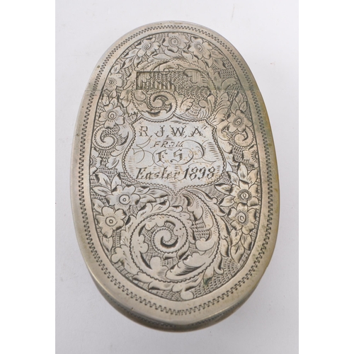 294 - A 19th century 1898 Victorian metal snuff box. The snuff box of oval curved form, with engraving ove... 