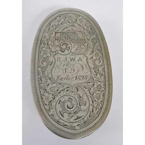 294 - A 19th century 1898 Victorian metal snuff box. The snuff box of oval curved form, with engraving ove... 