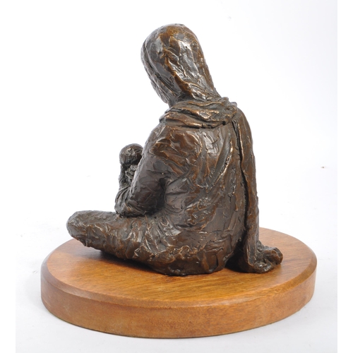 300 - A vintage 20th century spelter figure of female mother holding baby. Female wearing head dress with ... 