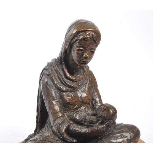 300 - A vintage 20th century spelter figure of female mother holding baby. Female wearing head dress with ... 