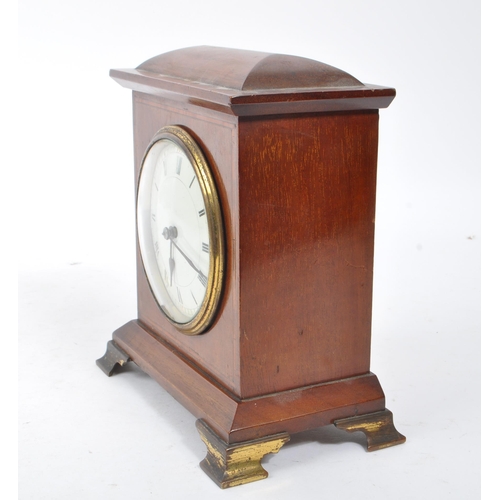 304 - An Edwardian walnut inlaid mantle clock with SRFA French movement having roman numerals to face. The... 