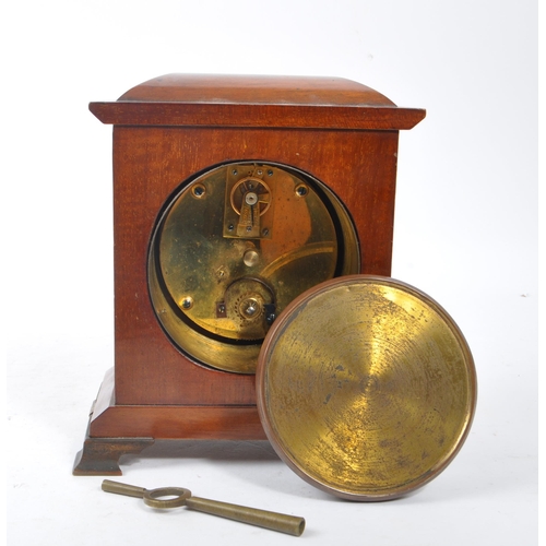 304 - An Edwardian walnut inlaid mantle clock with SRFA French movement having roman numerals to face. The... 