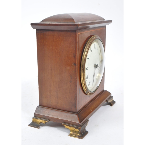 304 - An Edwardian walnut inlaid mantle clock with SRFA French movement having roman numerals to face. The... 