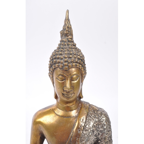 307 - A 20th Century painted bronze figure in the form of Buddha in seated position with legs crossed in s... 