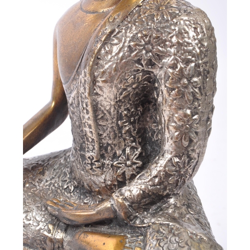 307 - A 20th Century painted bronze figure in the form of Buddha in seated position with legs crossed in s... 