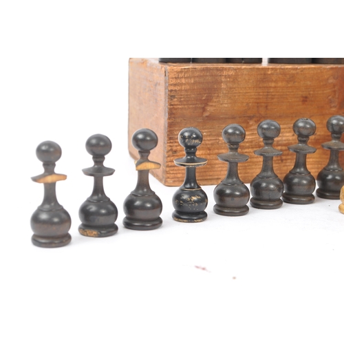 310 - An early 20th century boxed wooden chess set. The chess set featuring turned wooden pieces, with all... 