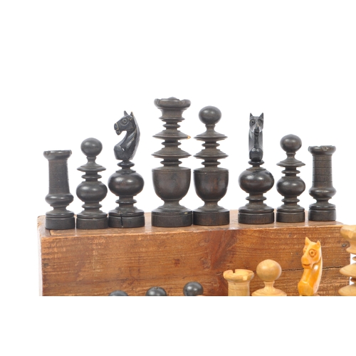 310 - An early 20th century boxed wooden chess set. The chess set featuring turned wooden pieces, with all... 