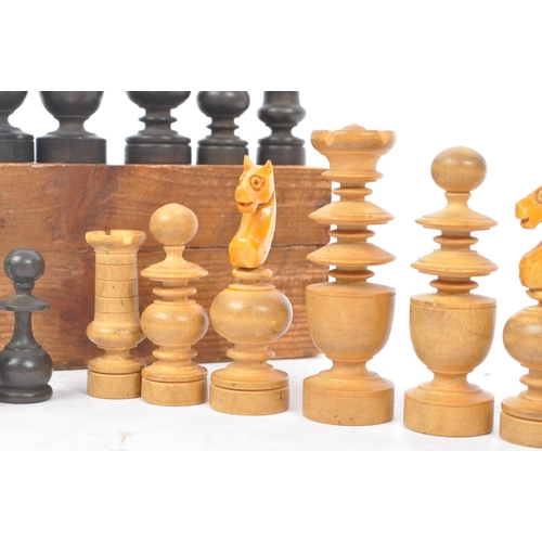 310 - An early 20th century boxed wooden chess set. The chess set featuring turned wooden pieces, with all... 