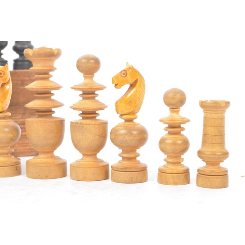 310 - An early 20th century boxed wooden chess set. The chess set featuring turned wooden pieces, with all... 